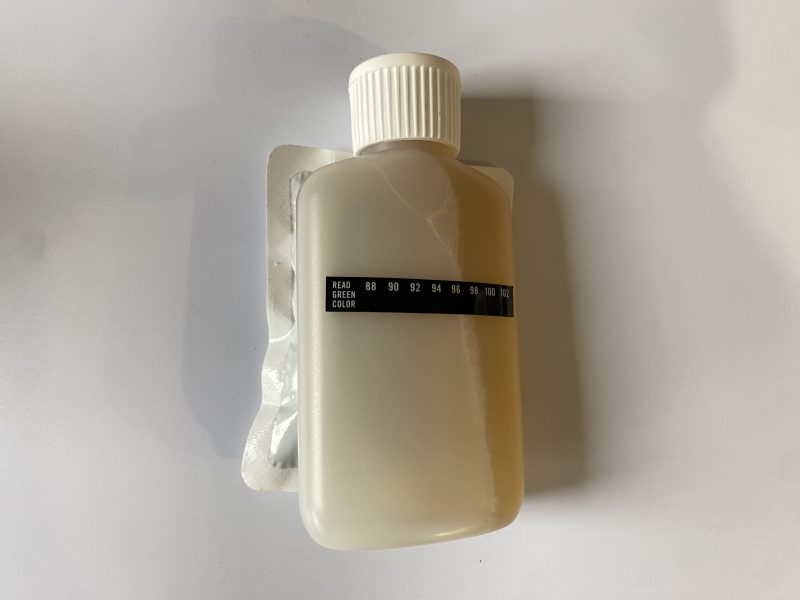 urine bottle with the heat pad attached